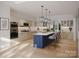 A spacious, modern kitchen boasts custom cabinets, a large island with seating, and stainless steel appliances at 5039 Eliza Long Wilkie Dr, Huntersville, NC 28078