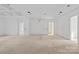 Bright living room featuring white walls, recessed lighting, and doorway views in this home at 5039 Eliza Long Wilkie Dr, Huntersville, NC 28078