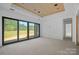 Spacious living room with sliding glass doors and wood plank ceiling at 5039 Eliza Long Wilkie Dr, Huntersville, NC 28078