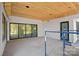 Covered patio with a wood plank ceiling and large sliding doors at 5039 Eliza Long Wilkie Dr, Huntersville, NC 28078