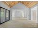 Unfinished room featuring a vaulted wood ceiling and large openings leading to other areas of the home at 5039 Eliza Long Wilkie Dr, Huntersville, NC 28078