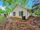 View of the home's exterior featuring a small patio and spacious backyard with mature trees at 6520 White Pine Ln, Charlotte, NC 28262