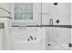 Bright bathroom featuring a glass-enclosed shower, soaking tub, and marble tiling for a spa-like experience at 6520 White Pine Ln, Charlotte, NC 28262