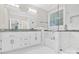 Bright bathroom with marble floors, a double sink vanity, tub and glass-enclosed shower at 6520 White Pine Ln, Charlotte, NC 28262