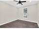 Cozy bedroom with hardwood floors, a modern ceiling fan, and a window providing ample natural light at 6520 White Pine Ln, Charlotte, NC 28262