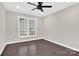 Bedroom featuring hardwood floors, a modern ceiling fan, and window that provides natural light at 6520 White Pine Ln, Charlotte, NC 28262