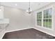 Bright dining area with a large window and modern chandelier fixture at 6520 White Pine Ln, Charlotte, NC 28262