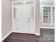 Welcoming entryway featuring sidelight windows, hardwood floors, and neutral-colored walls at 6520 White Pine Ln, Charlotte, NC 28262