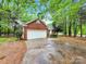 Traditional brick and vinyl home with a two-car garage and mature trees at 6520 White Pine Ln, Charlotte, NC 28262