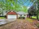 Charming single-story home with brick and vinyl siding, a two-car garage and green lawn at 6520 White Pine Ln, Charlotte, NC 28262