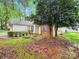 Home exterior showing the side yard, shrubs, and brick and vinyl siding at 6520 White Pine Ln, Charlotte, NC 28262