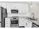 Modern kitchen equipped with stainless steel appliances and stylish white cabinets at 6520 White Pine Ln, Charlotte, NC 28262