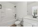 Bathroom with a shower-tub combo, white vanity, and dark hardware at 701 Applewood St, Kannapolis, NC 28081