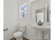 Bathroom featuring a pedestal sink, modern faucet, and coordinated fixtures under a bright window at 701 Applewood St, Kannapolis, NC 28081
