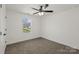 Bright carpeted bedroom with a window providing ample natural light at 701 Applewood St, Kannapolis, NC 28081