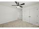 Bright bedroom featuring neutral carpet, ceiling fan with light and closet with double doors at 701 Applewood St, Kannapolis, NC 28081