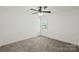 Bright, carpeted bedroom with a ceiling fan and a view from the window at 701 Applewood St, Kannapolis, NC 28081