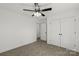 Bright bedroom featuring neutral carpet, ceiling fan with light and closet with double doors at 701 Applewood St, Kannapolis, NC 28081