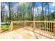 New wooden deck overlooks a lush, wooded backyard, perfect for relaxation at 701 Applewood St, Kannapolis, NC 28081