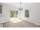 Dining area features modern chandelier lighting and sliding glass doors leading to an outdoor patio at 701 Applewood St, Kannapolis, NC 28081