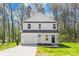 Charming two-story home boasts a symmetrical facade, attached garage, and freshly laid driveway on a verdant lawn at 701 Applewood St, Kannapolis, NC 28081