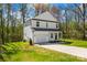 Attractive exterior view of a two-story white home with a well-maintained lawn and a concrete driveway leading to the garage at 701 Applewood St, Kannapolis, NC 28081