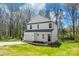 White two-story home on a green lawn features an attached garage, a concrete driveway, and an inviting front entrance at 701 Applewood St, Kannapolis, NC 28081