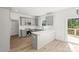 Open-concept kitchen features gray cabinetry, white subway tile backsplash, and stainless steel appliances at 701 Applewood St, Kannapolis, NC 28081