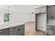 Spacious kitchen showcasing gray cabinets, white countertops, and seamless flow into an adjacent living space at 701 Applewood St, Kannapolis, NC 28081