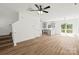 Open-concept living room with luxury vinyl plank flooring, a ceiling fan, and an opening into the kitchen at 701 Applewood St, Kannapolis, NC 28081