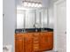 Bathroom featuring a double vanity with dark countertops and framed mirror at 706 Springwood Dr # 14, Waxhaw, NC 28173