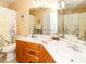 Well-lit bathroom with double vanity, framed mirror, and floral shower curtain at 706 Springwood Dr # 14, Waxhaw, NC 28173