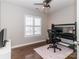 Bedroom with hardwood floors, window with blinds, and desk with multiple monitors at 706 Springwood Dr # 14, Waxhaw, NC 28173