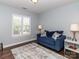 Bedroom with hardwood floor, window with blinds, and blue couch at 706 Springwood Dr # 14, Waxhaw, NC 28173