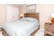 Bedroom with wood bed frame, ceiling fan, and closet with mirrored doors at 706 Springwood Dr # 14, Waxhaw, NC 28173