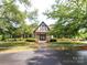 Charming clubhouse with Tudor detailing, set amidst lush landscaping and mature trees at 706 Springwood Dr # 14, Waxhaw, NC 28173