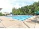 Large community pool surrounded by trees and lounge chairs, perfect for summer relaxation at 706 Springwood Dr # 14, Waxhaw, NC 28173