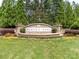 Stone community entrance with beautiful landscaping welcomes residents and guests to Wesley Oaks at 706 Springwood Dr # 14, Waxhaw, NC 28173