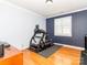 Well-lit exercise room with hardwood floors and treadmill, perfect for home workouts at 706 Springwood Dr # 14, Waxhaw, NC 28173