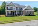 Charming two-story brick home with well-manicured lawn, black shutters and covered front porch at 706 Springwood Dr # 14, Waxhaw, NC 28173