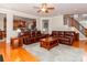 Open living room with hardwood floors, leather sofas, and view of kitchen and stairway at 706 Springwood Dr # 14, Waxhaw, NC 28173