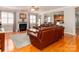 Spacious living room featuring a fireplace, hardwood floors, and comfortable leather seating at 706 Springwood Dr # 14, Waxhaw, NC 28173