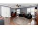 Cozy living room features hardwood floors, two black leather chairs, and plenty of natural light from the two windows at 706 Springwood Dr # 14, Waxhaw, NC 28173