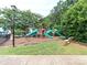 Community playground featuring slides and climbing structures, surrounded by trees and greenery at 706 Springwood Dr # 14, Waxhaw, NC 28173