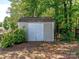 Exterior view of a storage shed surrounded by greenery, providing ample space for gardening tools and equipment at 706 Springwood Dr # 14, Waxhaw, NC 28173
