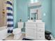 A well-lit bathroom with blue accents and shower curtain next to toilet and sink at 7278 Waterwheel St, Concord, NC 28025