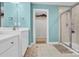 Bright and spacious bathroom featuring a walk-in shower, vanity, and storage shelves at 7278 Waterwheel St, Concord, NC 28025
