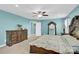 Spacious bedroom with elegant wood furniture, a ceiling fan, and calming blue walls at 7278 Waterwheel St, Concord, NC 28025