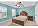 Bedroom with carpeted floors, a ceiling fan, and a wooden bed frame at 7278 Waterwheel St, Concord, NC 28025