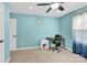 Blue bedroom featuring a modern desk with rolling chair and bright window light at 7278 Waterwheel St, Concord, NC 28025